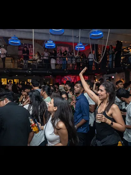 A wide shot of the packed floor at Watson's, with guests fully immersed in the party.