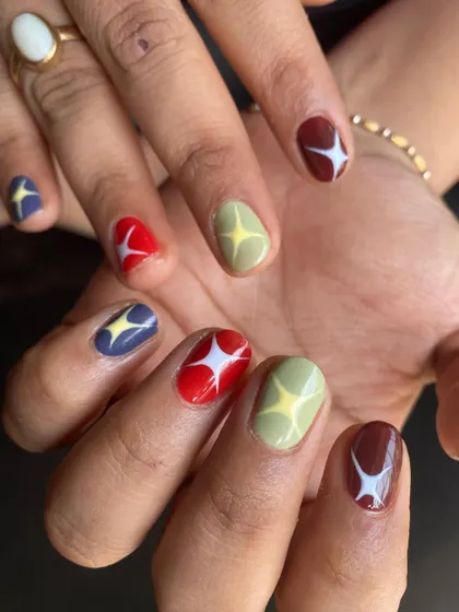 Another look at the colorful starburst nails, showing how the design looks across both hands.