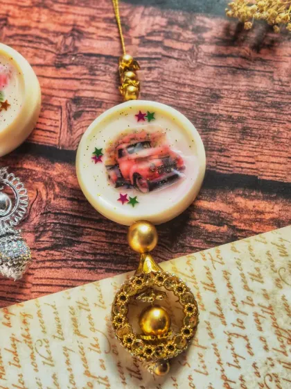This wardrobe freshener features a vintage car design and a beautiful golden latkan. It's not just functional but also a visually stunning accent piece.