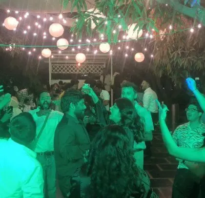 An English and South Indian fusion wedding party, with guests enjoying the outdoor setting.