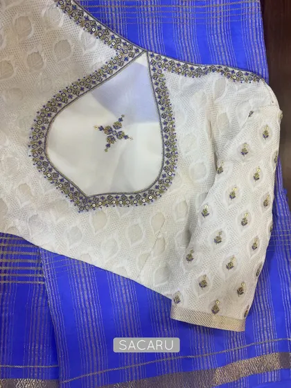 We love creating contrast. Here, we paired a rare blue Mysore silk saree with a custom off-white embroidered Georgette blouse with a unique back cutout.