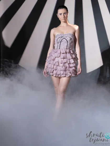 A walking shot from the Label.san campaign, with the model emerging from the smoke in a beautiful ruffled dress.