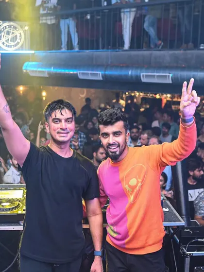 A duplicate of the B2B shot, emphasizing the fun and success of a collaborative night. Two DJs can bring double the energy.