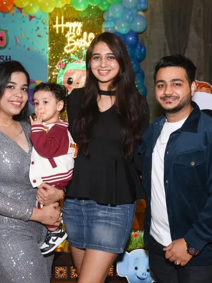 The birthday boy with his family, capturing a happy group memory.