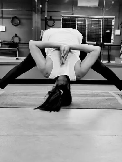A wide-legged forward bend with a shoulder-opening clasp. This yoga pose is excellent for stretching the inner thighs, hamstrings, and shoulders.