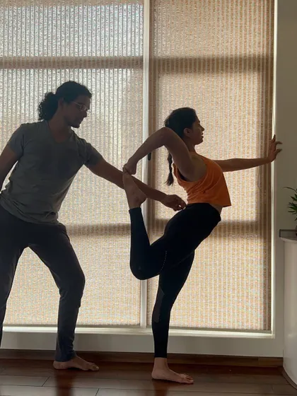 Another angle of hands-on assistance in Natarajasana, focusing on the beautiful balance between effort and ease.