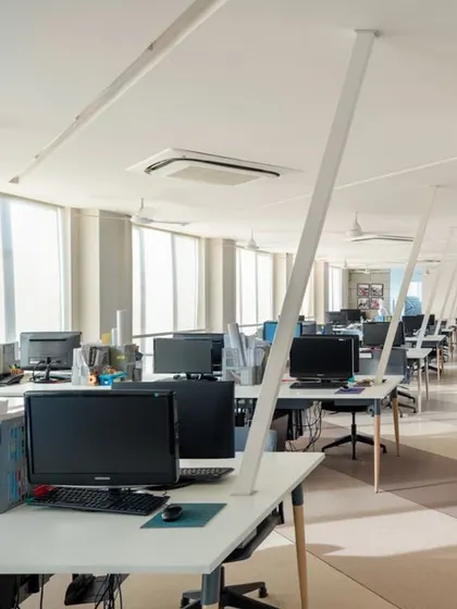 Our own studio is a laboratory for our design principles. The open-plan layout is bathed in natural light, with clean white workstations and diagonal conduits that serve as both a functional and aesthetic element, creating a clutter-free and inspiring environment.