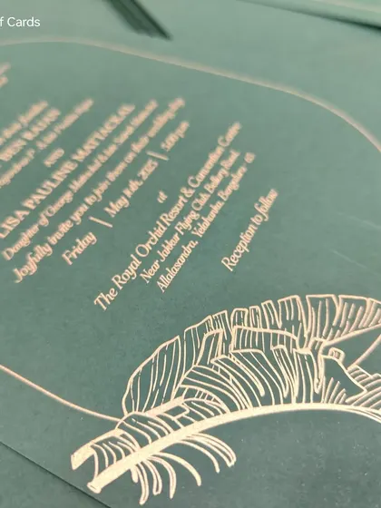 A close-up of the delicate feather motif, screen-printed in gold on a trendy Glass Glow Green paper. This minimalist design is both modern and elegant.