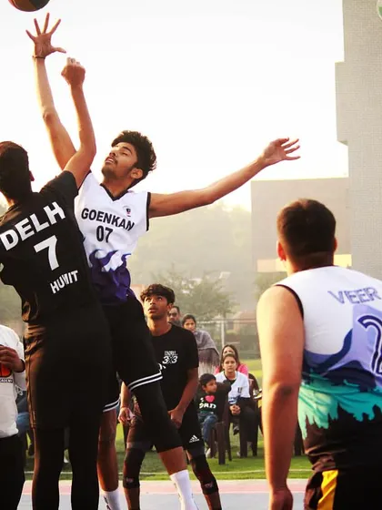 A classic jump ball situation, capturing the peak of action as two players compete for possession. This image shows the athleticism and competitive spirit that defines our games.
