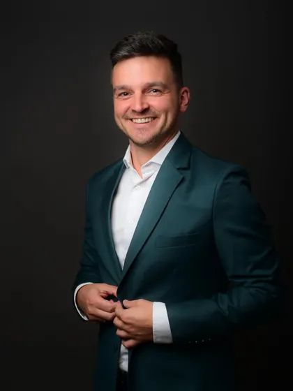 A simple adjustment, like buttoning a jacket, can create a candid and stylish moment in a corporate photoshoot, adding a touch of class.