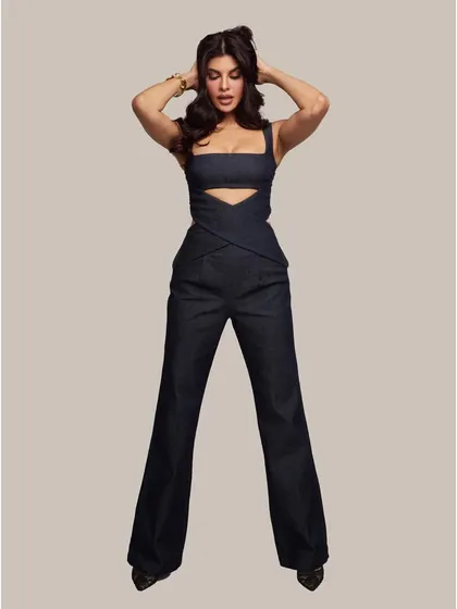 A full-length fashion portrait of Jacqueline Fernandez. This shot highlights her posture and the styling of the outfit, demonstrating her versatility as a model and performer.