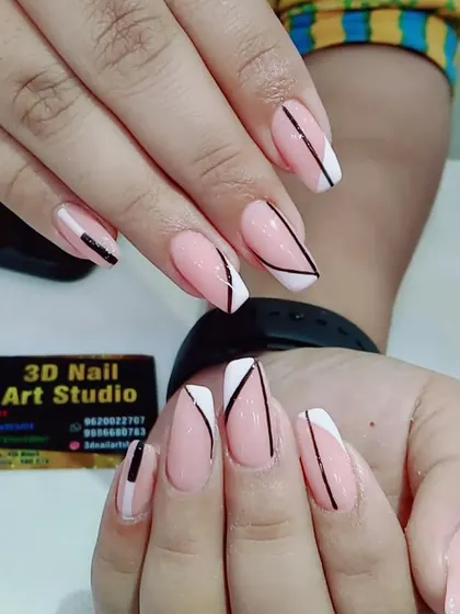 A graphic and modern take on the French manicure, with black and white geometric lines and shapes.