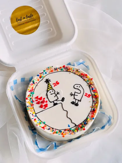 Another angle of the custom stick-figure birthday cake, showing the colorful sprinkle border that adds a festive touch to the design.