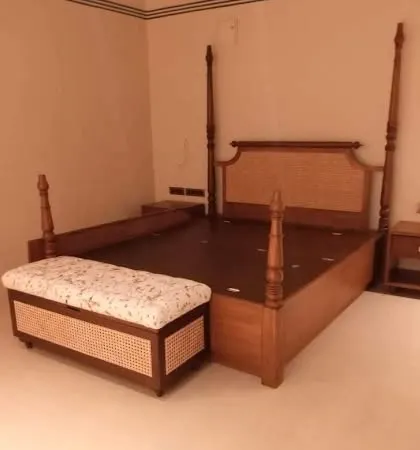 A beautiful four-poster bed made from teak wood with a cane-woven headboard. I also built the matching storage bench at the foot of the bed, which features cane detailing to tie the whole set together.