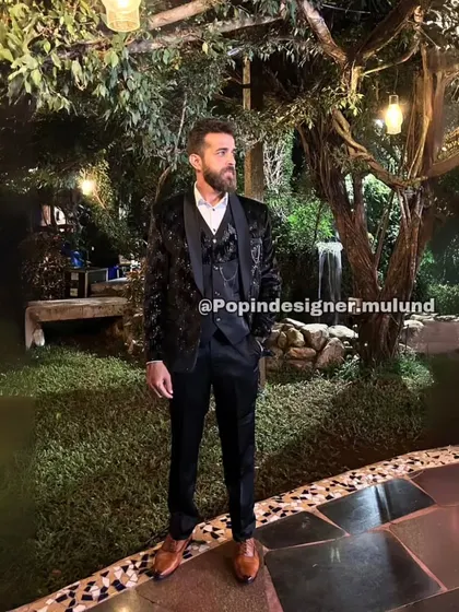 Here is the same client in our black textured suit, pictured in an outdoor garden setting. It shows how our formal wear is perfect for any upscale event, day or night.