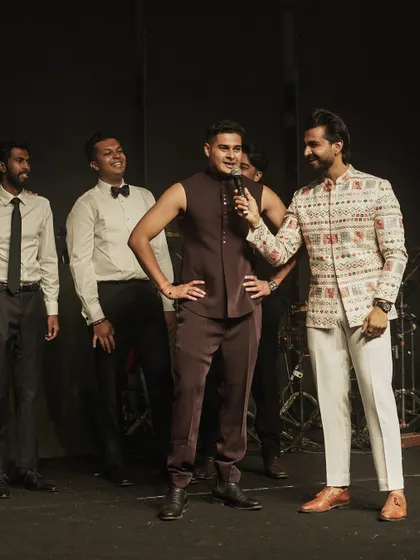 Engaging with the groomsmen during a Sangeet performance. My interactive style ensures that even the guests on stage are having a great time.