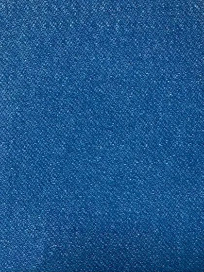 The texture of a bright blue denim. This non-stretch fabric has a classic, sturdy feel and a brilliant color that holds up well over time.