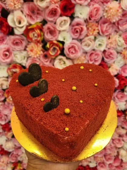 My Red Velvet cake in a heart shape, perfect for anniversaries or Valentine's Day. The rich red crumb coating and dark chocolate hearts make it a simple yet beautiful way to show your love.
