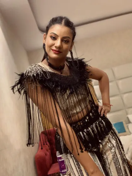 Getting ready backstage for a New Year's Eve performance. This costume, with its intricate fringe and sequin details, was designed for maximum movement and visual flair on stage.