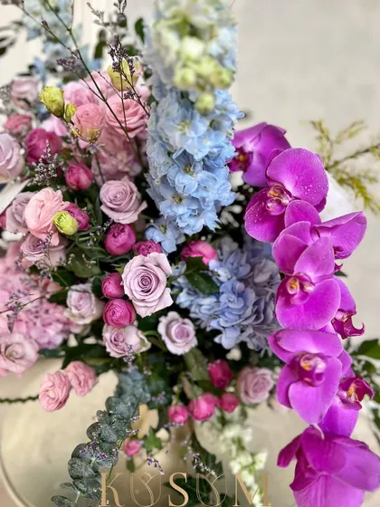 A detail shot of the cascading purple Phalaenopsis orchid in my "vintage novel" arrangement. Its vibrant color provides a stunning focal point against the softer pastel roses and hydrangeas.