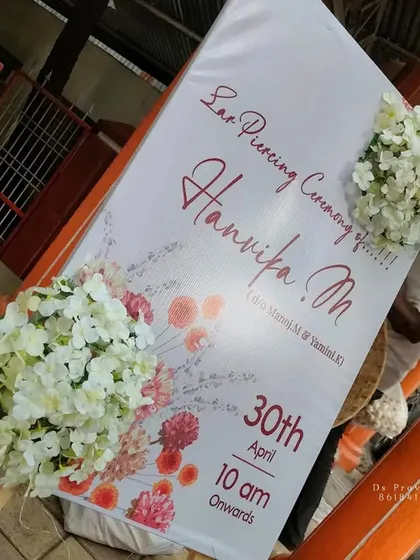 This is a simple and elegant welcome sign I designed for an ear piercing ceremony. The custom printed board is decorated with bunches of white hydrangeas for a clean and modern look.