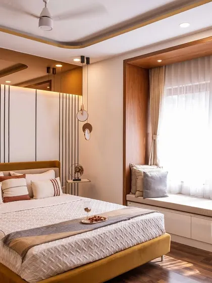 This bedroom design includes a comfortable window seat with hidden storage drawers, making smart use of space while providing a cozy nook for relaxation.