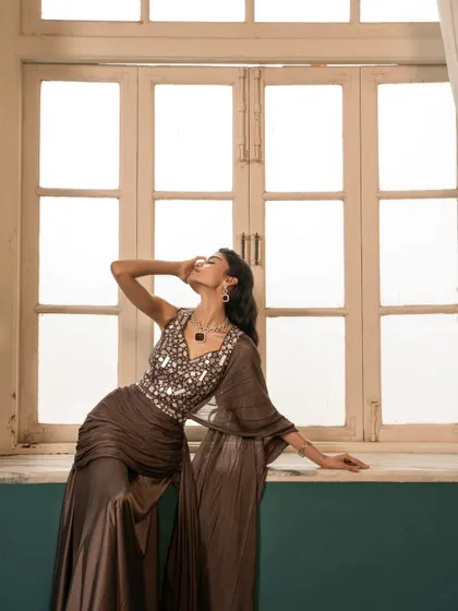 A dynamic pose by a window, using backlighting to create a beautiful silhouette and highlight the flow of the fabric.