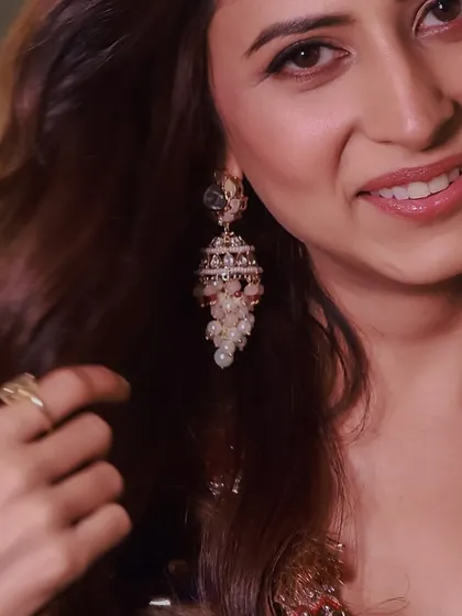 A close-up of the talented Sargun Mehta, her smile shining as she wears a pair of my pearl and polki jhumkas.