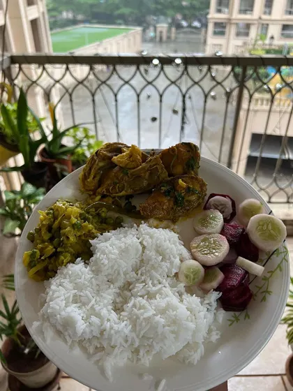 A simple home-cooked meal of fish curry, rice, and fresh salad. Eating well means incorporating traditional foods in a mindful way, ensuring your diet is both effective and enjoyable.