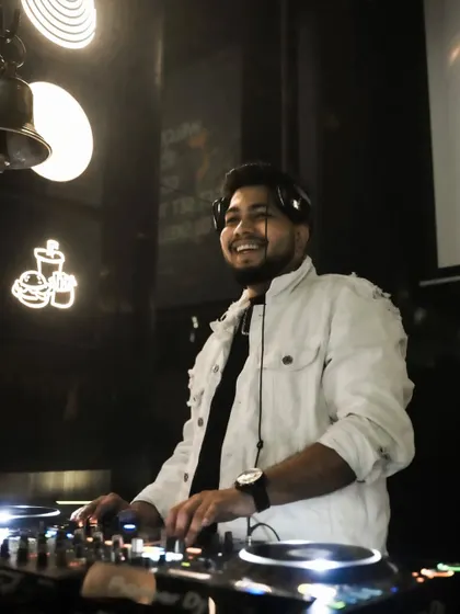 A candid smile behind the decks. I genuinely love what I do.