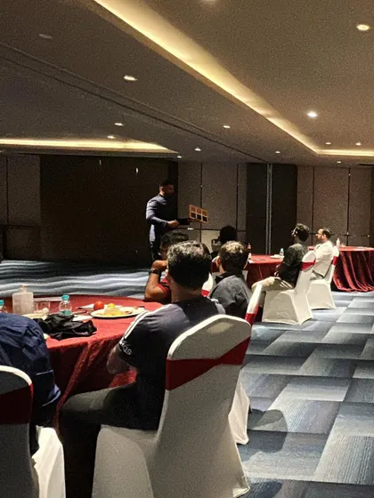Performing for a small, seated group in a boardroom setting. This format is perfect for leadership meetings or exclusive client events where a more personal touch is required.