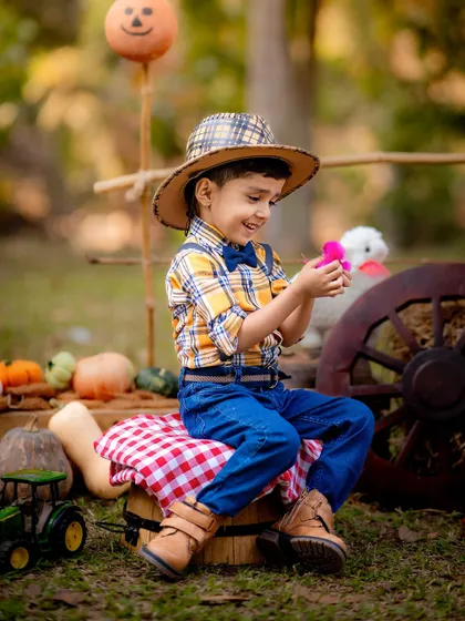 A duplicate of the farm theme image, showing the little boy's interaction with the props.