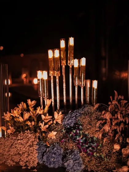 Another perspective on our candle and floral centerpieces. The mix of different flowers and the varying heights of the candles create visual interest and contribute to the luxurious, layered feel of the decor for this special birthday.
