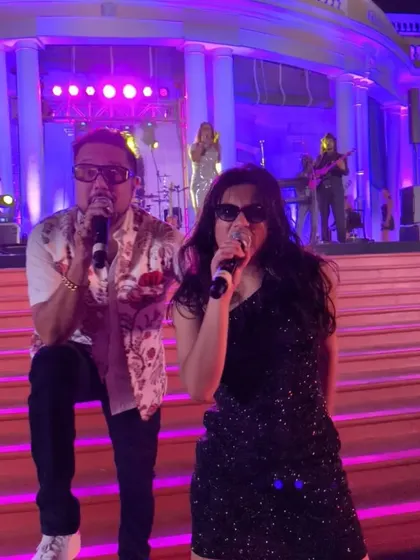A close-up of me and my mentor performing together at the Madras Club. This shot shows our strong connection and the dynamic energy we bring as front-persons for the band.