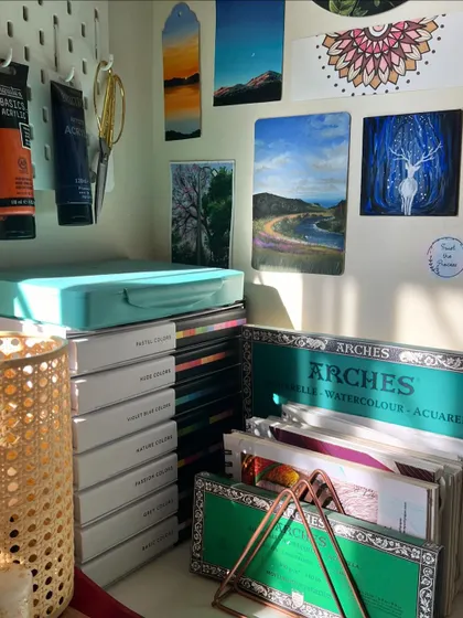 A close up of some of the smaller paintings on my wall, including the magical deer and a beautiful river landscape.