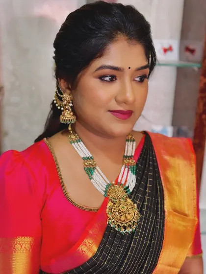 A side profile of Priya's soft glam makeup, highlighting the defined eye makeup and smooth skin finish.