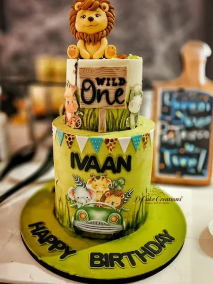 A party shot of the "Wild One" cake for Ivaan, showing how it perfectly complements a jungle-themed first birthday celebration.