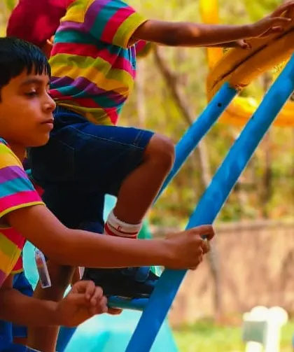 A student enjoys the see-saw, a simple pleasure and part of the fun and games during the farm visit.