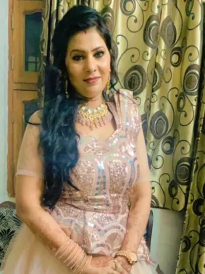 A happy client in a rose-gold sequined gown, perfect for an engagement or reception party.