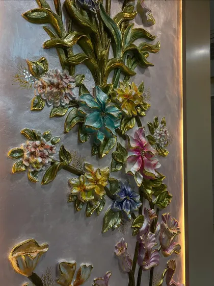 A close-up of the middle section of the floral mural. The 3D sculpting of the petals and leaves, combined with golden accents, creates a sense of depth and luxury.
