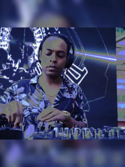 Mixing tracks against a futuristic, digital art background. The aesthetic of the event is just as important as the music.
