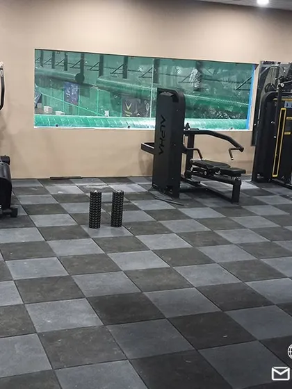 A view of our cardio and strength training zone, featuring treadmills, ellipticals, and multi-station gym machines for comprehensive workouts.