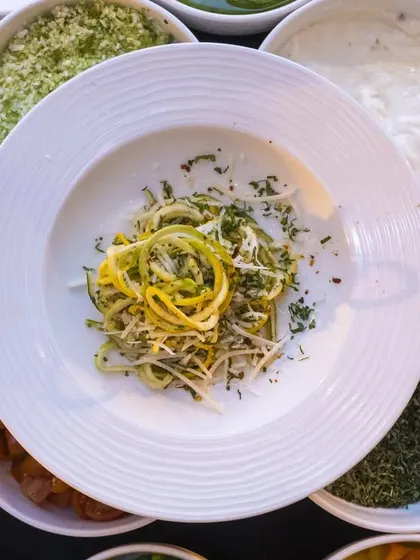 A healthy and vibrant zucchini noodle salad, showcasing our fresh and light options.