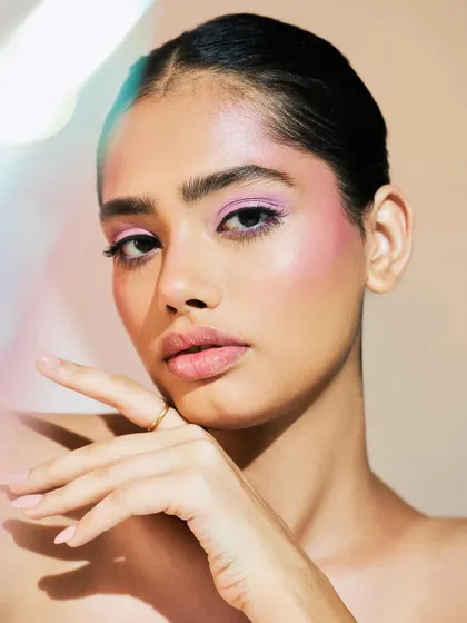 The addition of a prism effect in the photo enhances the ethereal quality of the makeup.