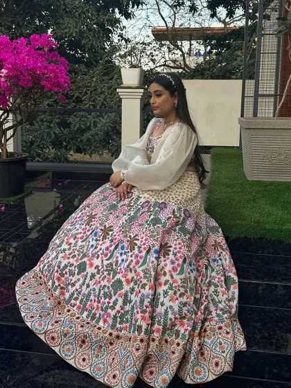 The way this heavily embroidered raw silk lehenga sits is just beautiful. It’s designed to create a grand, regal silhouette, making it an ideal choice for a wedding ceremony or a grand reception.