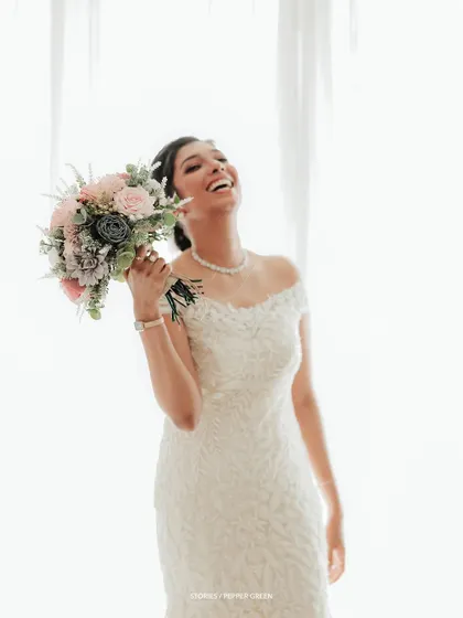 Another shot of pure, uninhibited joy, as the bride laughs heartily, her happiness radiating from the image.