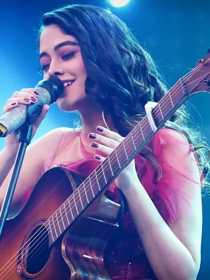 A close-up of me singing on stage. You can see the passion I have for music in my expression, and I bring that same dedication to your custom song.