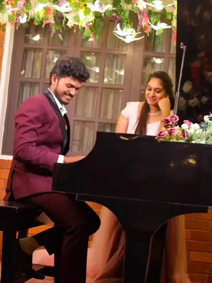Another angle from the piano pre-wedding shoot, showing the couple sharing a happy moment.