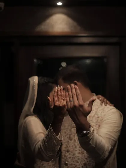 A playful and intimate "reveal" of the rings. This candid style of ring photography captures the couple's personality and the happy reality of being newly engaged.