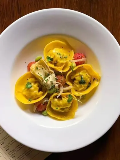 Yellow tortelli pasta, beautifully arranged in a light broth. A delicate and flavorful dish from my Thanksgiving menu.